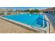 Outdoor pool with crystal clear water, surrounded by a brick patio and tropical landscaping at 7882 Sailboat Key S Blvd # 401, South Pasadena, FL 33707