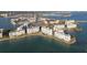 Stunning aerial view of waterfront condominiums with boat docks and city skyline in the distance at 7912 Sailboat Key S Blvd # 508, South Pasadena, FL 33707