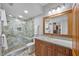 Well-lit bathroom featuring a spacious walk-in shower, modern vanity, and a large mirror for a luxurious feel at 7912 Sailboat Key S Blvd # 508, South Pasadena, FL 33707
