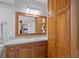 Bathroom featuring wood cabinets, a large mirror, and ample storage space at 7912 Sailboat Key S Blvd # 508, South Pasadena, FL 33707