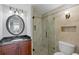 Elegant bathroom with a glass-enclosed shower, dark vanity, and stylish fixtures offers a sophisticated and comfortable space at 7912 Sailboat Key S Blvd # 508, South Pasadena, FL 33707