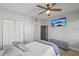 This bedroom is equipped with built-in closet, wooden floors, a ceiling fan, and a TV at 7912 Sailboat Key S Blvd # 508, South Pasadena, FL 33707
