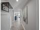 Long hallway features wood floors and neutral paint leading to a naturally lit living space with water views at 7912 Sailboat Key S Blvd # 508, South Pasadena, FL 33707