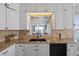 Open kitchen with granite countertops, tile backsplash, stainless steel appliances, and view to the living room at 7912 Sailboat Key S Blvd # 508, South Pasadena, FL 33707