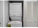 Convenient laundry area with a stacked washer and dryer unit and ample storage space, enhancing practicality and organization at 7912 Sailboat Key S Blvd # 508, South Pasadena, FL 33707