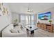 Cozy living room featuring a plush sofa, modern decor, wood floors, and a scenic view, offering a stylish and comfortable space at 7912 Sailboat Key S Blvd # 508, South Pasadena, FL 33707