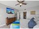 Bright bedroom features large bed, ceiling fan, dresser, and nearby laundry room access, next to en-suite at 7912 Sailboat Key S Blvd # 508, South Pasadena, FL 33707