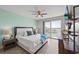 Comfortable main bedroom featuring a waterfront balcony and stylish furniture at 7912 Sailboat Key S Blvd # 508, South Pasadena, FL 33707