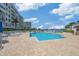 Community pool surrounded by lounge chairs, landscaping, and waterfront views at 7912 Sailboat Key S Blvd # 508, South Pasadena, FL 33707