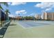 Outdoor tennis courts surrounded by lush landscaping and nearby condominium buildings at 7912 Sailboat Key S Blvd # 508, South Pasadena, FL 33707