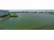Expansive waterfront view showcasing tranquil waters, verdant landscaping, and buildings in the distance at 7912 Sailboat Key S Blvd # 508, South Pasadena, FL 33707