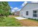 Backyard featuring a partial view of the house with lush greenery and a patio area at 8561 Deer Chase Dr, Riverview, FL 33578