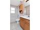 Bright bathroom featuring a shower-tub combination with white tile and a wood vanity with a white countertop and sink at 8561 Deer Chase Dr, Riverview, FL 33578