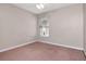 A serene bedroom with plush carpet and a window providing natural light at 8561 Deer Chase Dr, Riverview, FL 33578