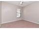 Neutral bedroom with a ceiling fan and a window with blinds, offering a simple and comfortable space at 8561 Deer Chase Dr, Riverview, FL 33578