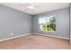 Comfortable bedroom with a large window, ceiling fan, neutral walls and carpeted flooring at 8561 Deer Chase Dr, Riverview, FL 33578