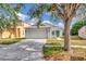 Charming single-story home featuring a well-maintained lawn, two-car garage and quaint front porch and an inviting turquoise door at 8561 Deer Chase Dr, Riverview, FL 33578