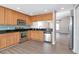 Spacious kitchen equipped with stainless steel appliances, wood cabinets, and granite countertops at 8561 Deer Chase Dr, Riverview, FL 33578