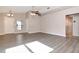 Bright living room with neutral walls, vaulted ceiling, ceiling fan, luxury vinyl plank flooring and view of the entry door at 8561 Deer Chase Dr, Riverview, FL 33578