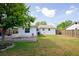 Large backyard with lawn and patio featuring an adjacent white house at 9118 108Th Ave, Seminole, FL 33777