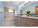 Well-lit bathroom featuring a double vanity and bath/shower combination at 9118 108Th Ave, Seminole, FL 33777