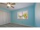 Bright bedroom with ceiling fan and window overlooking trees at 9118 108Th Ave, Seminole, FL 33777