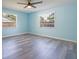 Bright empty bedroom features new flooring, ceiling fan, and two large windows at 9118 108Th Ave, Seminole, FL 33777