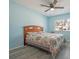 A clean bedroom with ceiling fan, gray flooring and view to the back yard at 9118 108Th Ave, Seminole, FL 33777