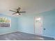 Well lit empty bedroom features a ceiling fan, two large windows, and access to the back yard at 9118 108Th Ave, Seminole, FL 33777