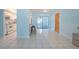 Bright dining area view with tile flooring, leading into a galley kitchen and outdoor access through sliding glass doors at 9118 108Th Ave, Seminole, FL 33777