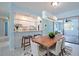 Open-concept dining area featuring a dining table, modern lighting, and seamless flow to the kitchen at 9118 108Th Ave, Seminole, FL 33777