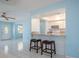 Open dining space overlooking the kitchen, featuring bar stool seating and a brightly painted interior at 9118 108Th Ave, Seminole, FL 33777