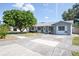Charming single-story home featuring a well-maintained front yard and a concrete driveway on a sunny day at 9118 108Th Ave, Seminole, FL 33777