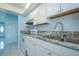 Updated kitchen with granite counters, white cabinets, and tile backsplash at 9118 108Th Ave, Seminole, FL 33777