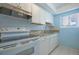 Modern kitchen featuring white cabinets, granite countertops, and updated appliances at 9118 108Th Ave, Seminole, FL 33777