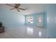 Neutral living room featuring tile flooring and a large window providing natural light at 9118 108Th Ave, Seminole, FL 33777