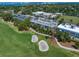 Stunning aerial view of real estate, adjacent to a lush golf course with manicured greens at 919 Osceola Rd # 202, Belleair, FL 33756