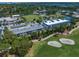 An aerial view showcasing real estate near a beautiful golf course and manicured greens at 919 Osceola Rd # 202, Belleair, FL 33756