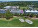 Aerial view showcases a building with golf course frontage, close to amenities at 919 Osceola Rd # 202, Belleair, FL 33756