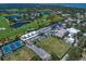 An aerial view showcasing real estate near a beautiful golf course, tennis court, and soccer field at 919 Osceola Rd # 202, Belleair, FL 33756