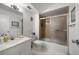 Well-lit bathroom showcasing a vanity with marble countertop and a shower-tub combination at 919 Osceola Rd # 202, Belleair, FL 33756