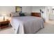 Bedroom with a comfortable bed, stylish decor, and view into the bathroom at 919 Osceola Rd # 202, Belleair, FL 33756