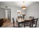 Bright dining area with a stylish table set for six, adjacent to the living room and kitchen, perfect for Gathering meals at 919 Osceola Rd # 202, Belleair, FL 33756