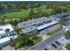 An aerial view of a charming condo building featuring covered parking and lush landscaping at 919 Osceola Rd # 202, Belleair, FL 33756