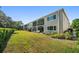 Exterior of a building with neatly kept green space creating a serene setting at 919 Osceola Rd # 202, Belleair, FL 33756