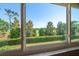 Breathtaking view of the lush green golf course through the condo's expansive windows, offering a serene and picturesque setting at 919 Osceola Rd # 202, Belleair, FL 33756