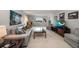 Light-filled living room with comfortable seating, neutral decor, and picturesque views of the outdoors through a large window at 919 Osceola Rd # 202, Belleair, FL 33756