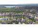 Aerial view showcasing residential homes bordering a serene lake and lush green trees at 1134 Tracey Ann Loop, Seffner, FL 33584