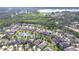 Aerial view showcasing houses in a lakeside community with lush greenery, mature trees, and tranquil waterways at 1134 Tracey Ann Loop, Seffner, FL 33584