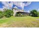 Spacious backyard featuring a screened-in patio, manicured landscaping, and lush green lawn at 1134 Tracey Ann Loop, Seffner, FL 33584